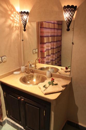 a bathroom with a sink and a mirror at Dar Asdika in Marrakesh