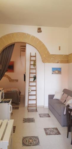 a living room with a staircase and a couch at La Culla di Adeodata in Marsala