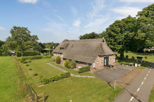 an aerial view of a house with a yard at De Deelderij in Schoonloo