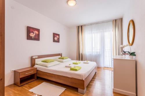 a bedroom with a bed and a large window at Apartment M&M in Split