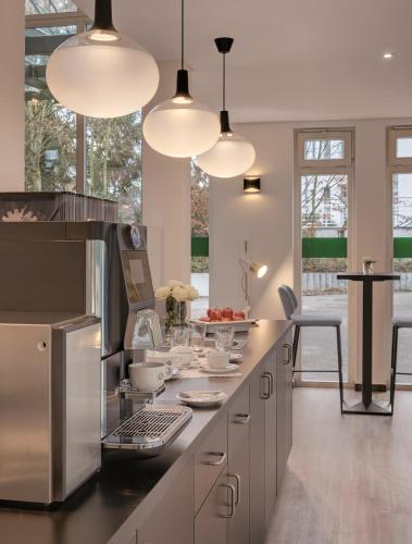 a kitchen with several lights and a counter with dishes at Hotel the YARD Bad Honnef in Bad Honnef am Rhein