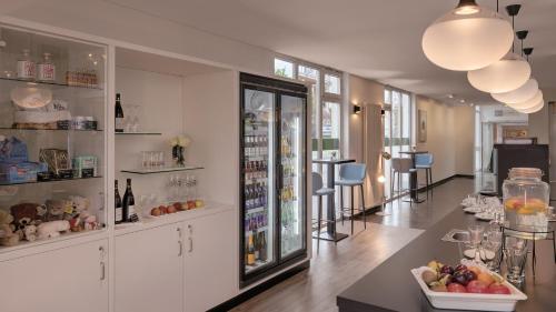 a room with white cabinets and a counter with fruit on a table at Hotel the YARD Bad Honnef in Bad Honnef am Rhein