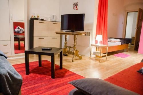 a living room with a tv and a table at Rooms and Apartment Veral-KA in Karlovac