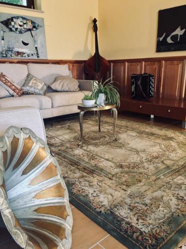 a living room with a couch and a table at Villa Brettino- Pesaro mare e cultura - intera struttura con piscina in Fano