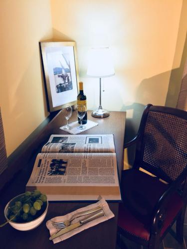 a table with a glass of wine and a bowl of fruit at Villa Brettino- Pesaro mare e cultura - intera struttura con piscina in Fano