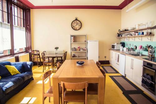 a kitchen and living room with a table and a couch at Murray Library Hostel in Anstruther