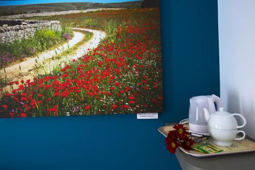 a painting of a field of flowers on a wall at B&B Arco Caputi in Ruvo di Puglia
