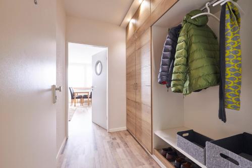 a room with a hallway with a closet and a table at Weserdeichblick in Bremerhaven