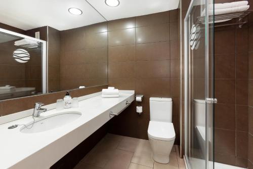 a bathroom with a toilet and a sink and a shower at PlayaOlid All Inclusive in Adeje