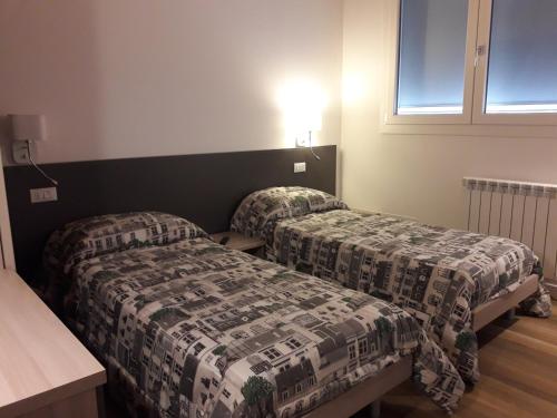 מיטה או מיטות בחדר ב-Locanda Mirafiori
