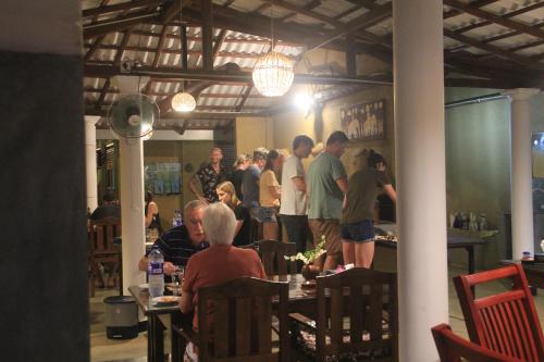 a group of people standing in a restaurant at Nature House in Udawalawe