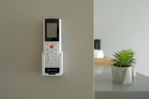 a cell phone is attached to a wall at Senamiesčio apartamentai in Tauragė