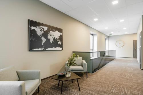 a lobby with a map of the world on the wall at Senamiesčio apartamentai in Tauragė