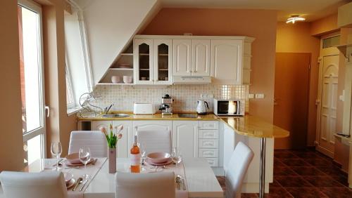 A kitchen or kitchenette at Lelle Central Grand Apartman