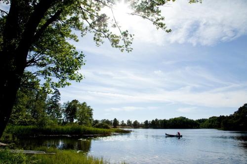 a person in a boat on a river at Ekebacken Hotell & Konferens in Markaryd