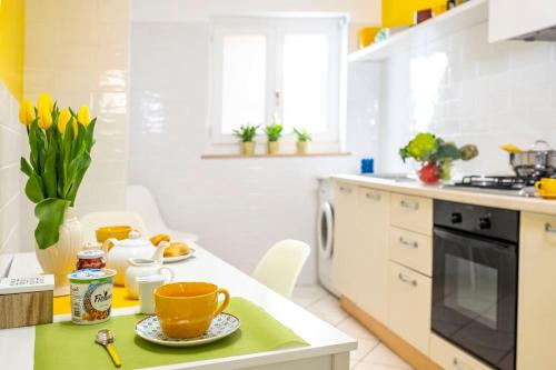 a kitchen with a green and white counter top at Maison M. - Luxury Apartment in Piazza Tasso in Sorrento