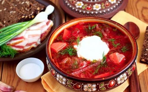 a bowl of soup with meat and dill on a table at Kitica house in Verkhovyna