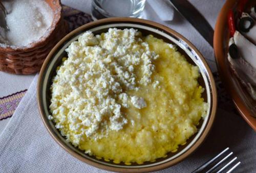 a bowl of cheese on a table with a fork at Kitica house in Verkhovyna
