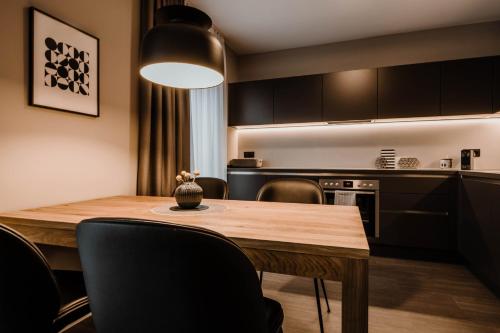 a kitchen with a dining room table and chairs at Timehouse Serviced Apartments in Munich