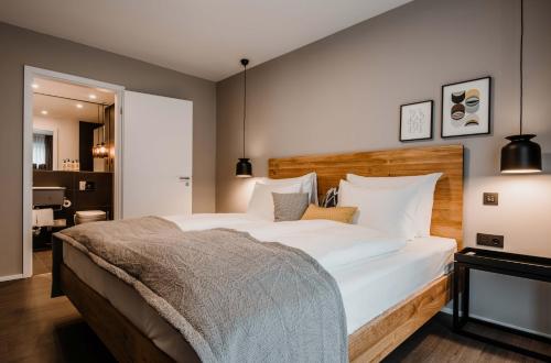 a bedroom with a large bed with white pillows at Timehouse Serviced Apartments in Munich