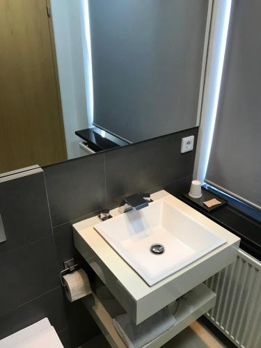 a bathroom with a white sink and a mirror at REK Inn in Reykjavík