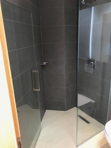 a bathroom with a shower with a glass door at REK Inn in Reykjavík