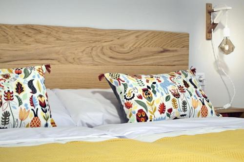 a bed with two pillows on top of it at Apartamento Estella-Lizarra in Estella