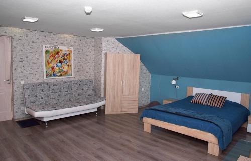 a bedroom with a bed and a bench in it at Central Riverside Apartments in Jēkabpils