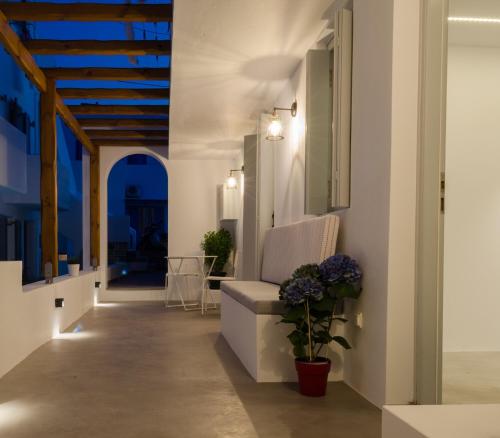 a hallway of a house with a chair and a table at L’arco Milos Suite in Adamas