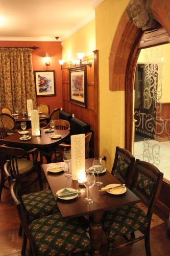 a restaurant with wooden tables and chairs and a table and chairsktop at The Dibbinsdale Inn in Bromborough