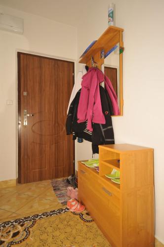 a room with a dresser and a wooden door at Apartmán Tatry-Nová Lesná in Nová Lesná