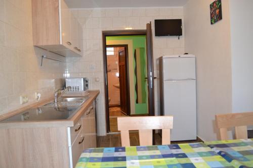 a kitchen with a sink and a refrigerator at Apartment Holiday Lungötz in Annaberg im Lammertal