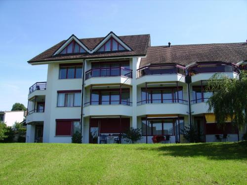 a large white building with a brown roof at Apart Holidays in Morschach