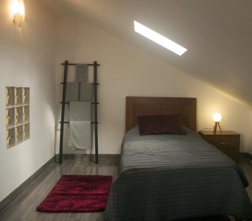 a bedroom with a bed and a book shelf at Friendly Peniche Apartment in Peniche