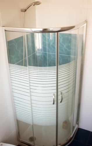 a shower with a glass enclosure in a bathroom at Friendly Peniche Apartment in Peniche