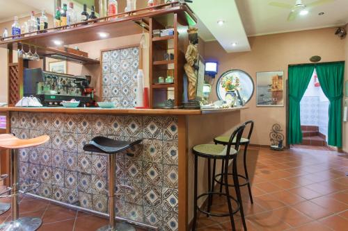 a bar with two stools at a counter at Hotel Toledo in Naples