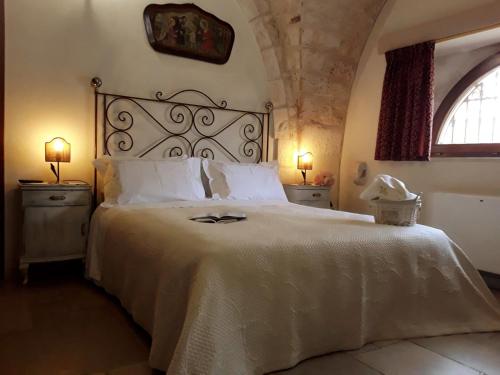 a bedroom with a large bed with a white bedspread at Masseria Tolla in Ostuni