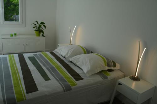 a bedroom with a bed with two lamps on it at Rullyoloft in Rully