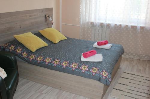 a bedroom with a bed with towels on it at Apartament Izabella in Suwałki