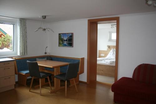 a room with a table and chairs and a bedroom at Haus Bergliebe in Schladming