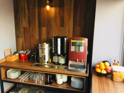 a coffee machine on a shelf with plates at Set Özer Hotel in Canakkale
