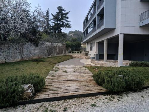 a walkway in front of a building next to a building at Romana Dream apartment in Vrsar