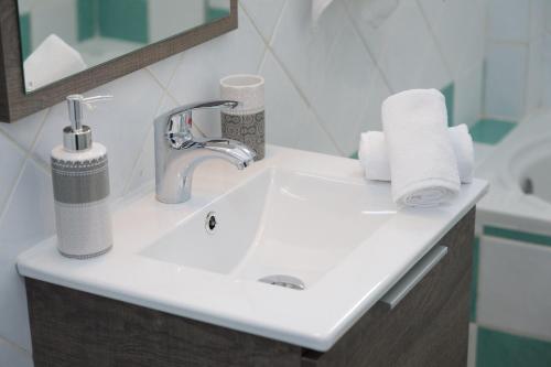a bathroom with a sink with towels on it at Syriti Studios in Skala Kefalonias