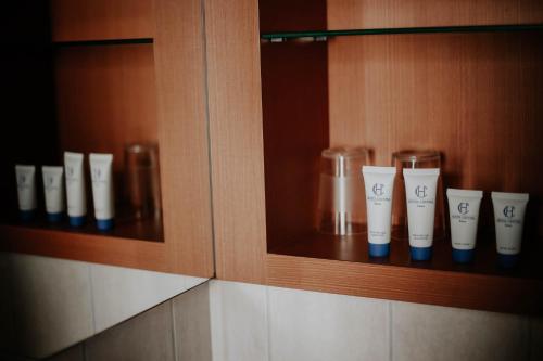 a cabinet with some cups on a shelf at Hôtel Crystal Reims Centre in Reims