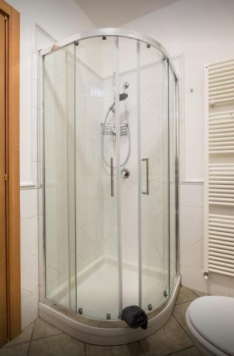 a shower with a glass enclosure in a bathroom at Portobello Apartments in Bologna
