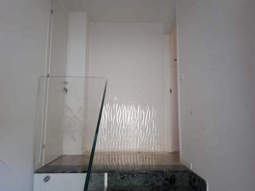 un ascenseur en verre dans une chambre avec un mur blanc dans l'établissement Appartamento rimodellato seconda fila mare centro di Cupra Marittima, à Cupra Marittima