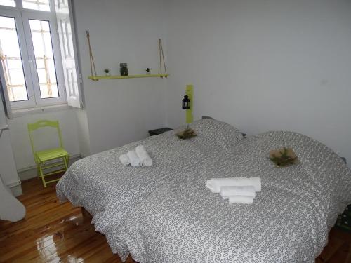 a bedroom with a bed with towels on it at Penhas da Saúde in Penhas da Saúde