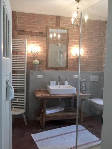 a bathroom with a sink and a mirror at Appartment Chupferschmied - Wohlfühlen im Altstadtambiente in Schopfheim