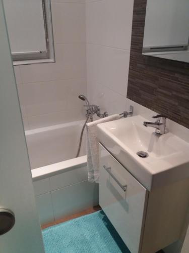 a bathroom with a sink and a bath tub with a sink at St. Julians homestay in St Julian's