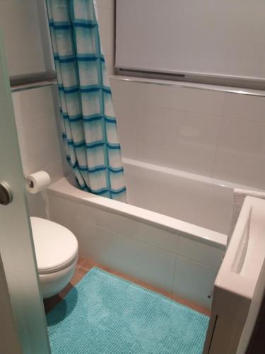 a bathroom with a toilet and a bath tub at St. Julians homestay in St Julian's